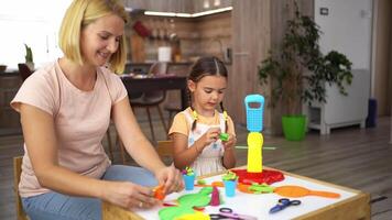 Creative moments shared between a mother and daughter in a colorful crafting session at home video