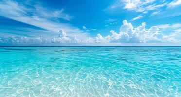 The blue ocean is calm and clear, with a few clouds in the sky photo