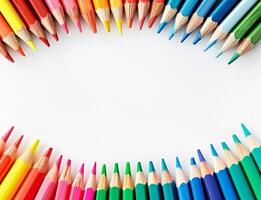 A row of colourful pencils are arranged in a circle isolated on a white background photo
