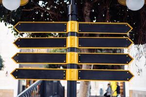 Directional signpost with multiple blank arrows in an urban setting during daylight hours. photo