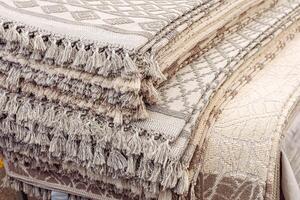 Woven textiles stacked neatly at a market showcasing intricate patterns and textures photo