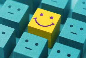 Varieties of Mood and Emotion. Mind, Mental Health Concept. a Unique Smiling Cube that Stand Out among Crowd photo