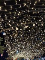 Enchanting night sky filled with glowing string lights creating a magical atmosphere in a festive outdoor setting under the stars photo