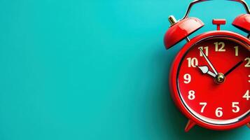 Red vintage alarm clock on vibrant turquoise background signifies time management and punctuality through retro design. Deadline approaching photo