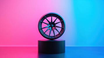 Sleek black alloy wheel displayed on minimalist pedestal with vibrant blue and pink gradient background illuminating the scene. Tires with rubber tread on alloy wheels photo