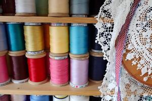 Cottagecore lace and thread in vintage sewing nook photo