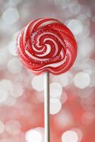 Red and White Swirled Lollipop on Sparkling Background photo