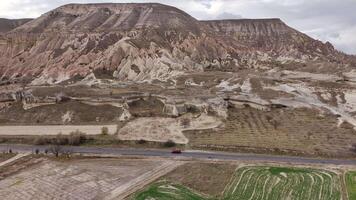 Aerial view of a road passing through Cappadocia's valleys and fields video
