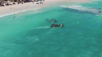 Aerial view of a boat with tourists sailing on crystal-clear waters video