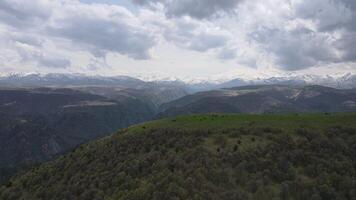 The sky is cloudy and the mountains are covered in snow video