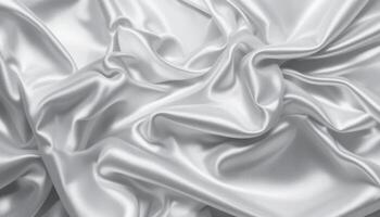 Luxurious silver satin fabric draped in elegant folds. photo