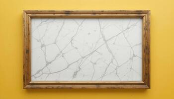 Empty gilded frame holding a white marble pattern on a mustard background. photo