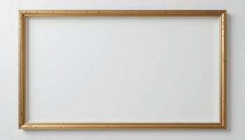 Empty gold picture frame against a plain background. photo