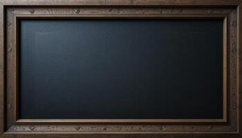 Dark chalkboard framed by wooden border. photo