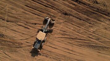 Grader leveling ground on construction site. Clip video