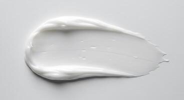 A white liquid is sitting on top of a white surface photo