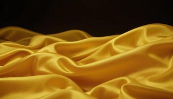 Golden satin fabric drapes in folds against a dark background. photo