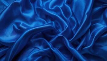 Luxurious folds of deep blue silk fabric. photo