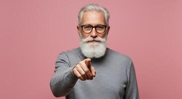 An old man with a white beard and glasses pointing at something photo