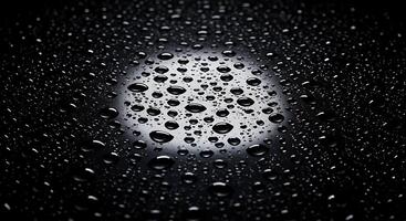 A black and white photo of water droplets on a surface