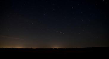 A night sky with a comet and a shooting star photo