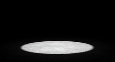 A white light shines on a black surface photo