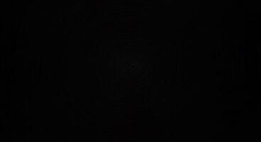A black background with a circular pattern photo