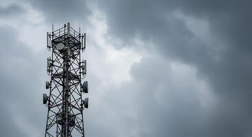 Cell tower with cloudy sky background photo