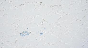 A white wall with paint peeling off of it photo