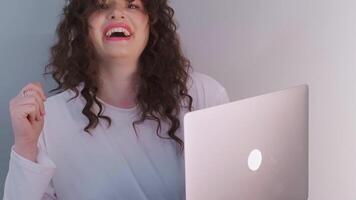 Passionate DJ with curly hair, wearing wireless headphones, singing and dancing while creating a new track, immersed in the process. video