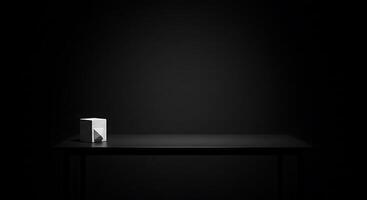 A black table with a white cube on it photo