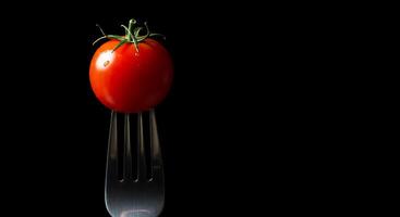 A fork with a tomato on it photo