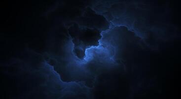 A dark blue cloud with a light coming from it photo