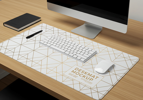 A clean desk setup with a geometric desk mat keyboard mouse and notebook psd