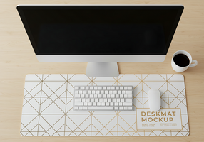 A minimalist workspace featuring a desktop computer keyboard mouse and coffee cup on a geometric desk mat psd