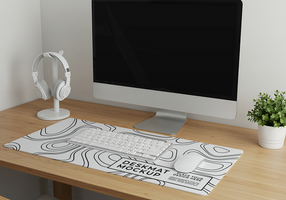 A clean minimalist workspace features a deskmat mockup with a keyboard mouse and headphones psd