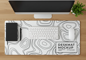 A minimalist desk setup featuring a topographic desk mat computer keyboard mouse and notebook psd