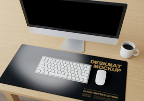 A clean desk setup with a computer keyboard mouse and coffee cup on a dark desk mat psd