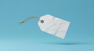 White paper price tag hanging from string on blue background photo