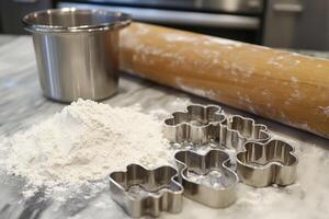 Flour, rolling pin, cookie cutters and mixing bowl preparing baking ingredients photo