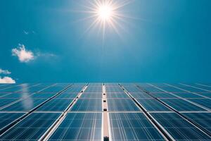 Solar panels converting sunlight into green energy under a bright sun photo