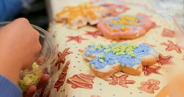 Child Decorating Cookies with Colorful Icing and Sprinkles video