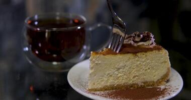 A person is enjoying a slice of Matcha Burnt Cheesecake by cutting it with a small fork. video