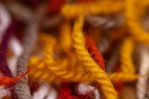 A mix of bright, soft skeins of yarn for knitting, captured in macro with shallow depth of field. Great for creative and cozy visuals. photo