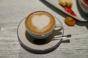 Delightful coffee art with a heart shape crafted atop a creamy surface in a cozy cafe setting photo