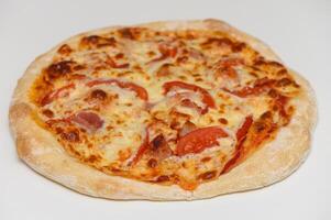 Rustic-style pizza topped with cheese, bacon, and tomato slices, fresh from the oven. Great for culinary websites and menus. photo