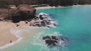 Aerial view of rocky coastline and turquoise waters on Lombok, Indonesia video