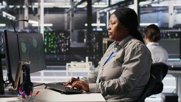 Scared data center technicians reacting to virus warning on PC display, scrambling to launch emergency response protocol. Admins run around server room, urgently trying to fix hacked systems, camera A video