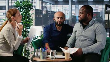 Group argument in a corporate office between diverse professionals, involving negotiation conflict and commitment issues. Business meeting with leadership frustration. Camera B. video