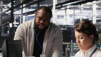 Jolly data center engineering team pleased after finishing system maintenance on supercomputers. Upbeat serve room coworkers satisfied by successful AI model training results on PC, camera A video